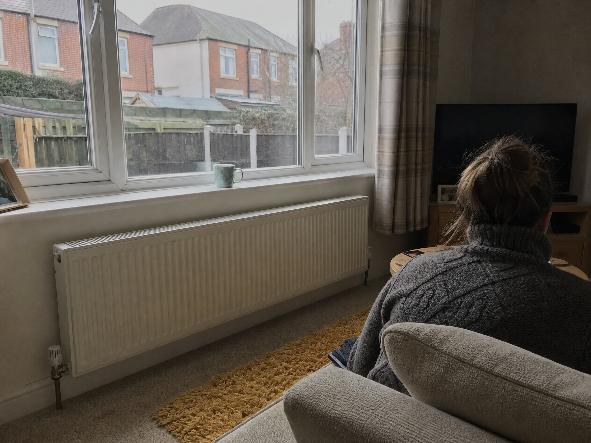 Warm living room in a British home heated by a heat pump through wall radiators