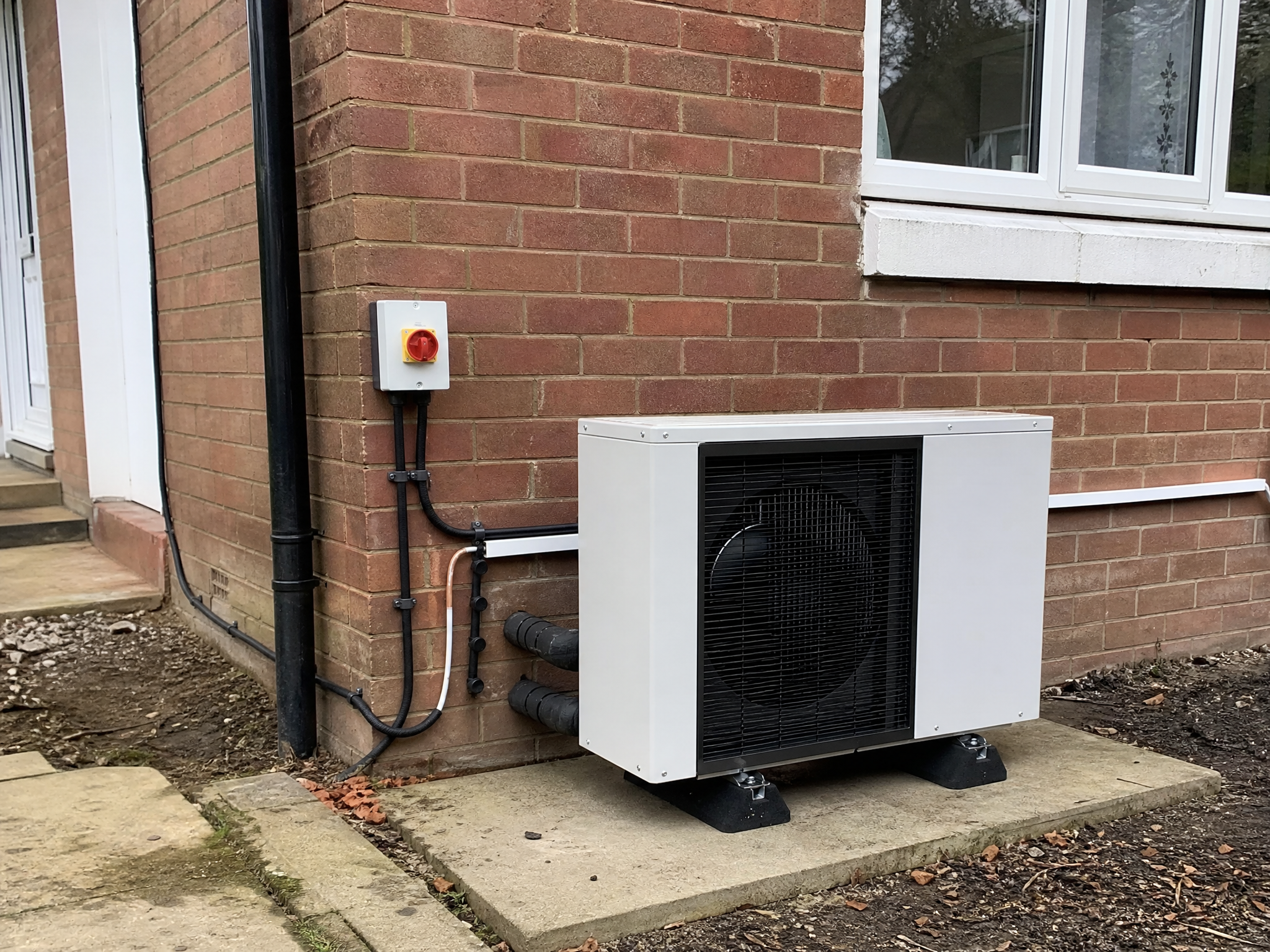 Completed gas boiler to heat pump replacement showing professional quality workmanship in a British home