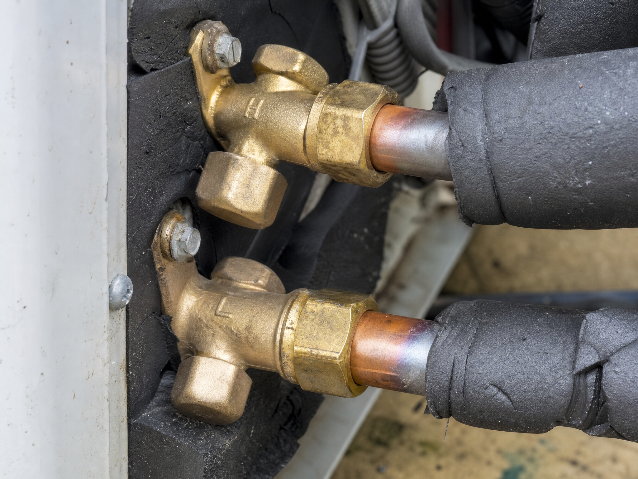 Close-up detail of materials and technique used in heat pump repairs — showing quality